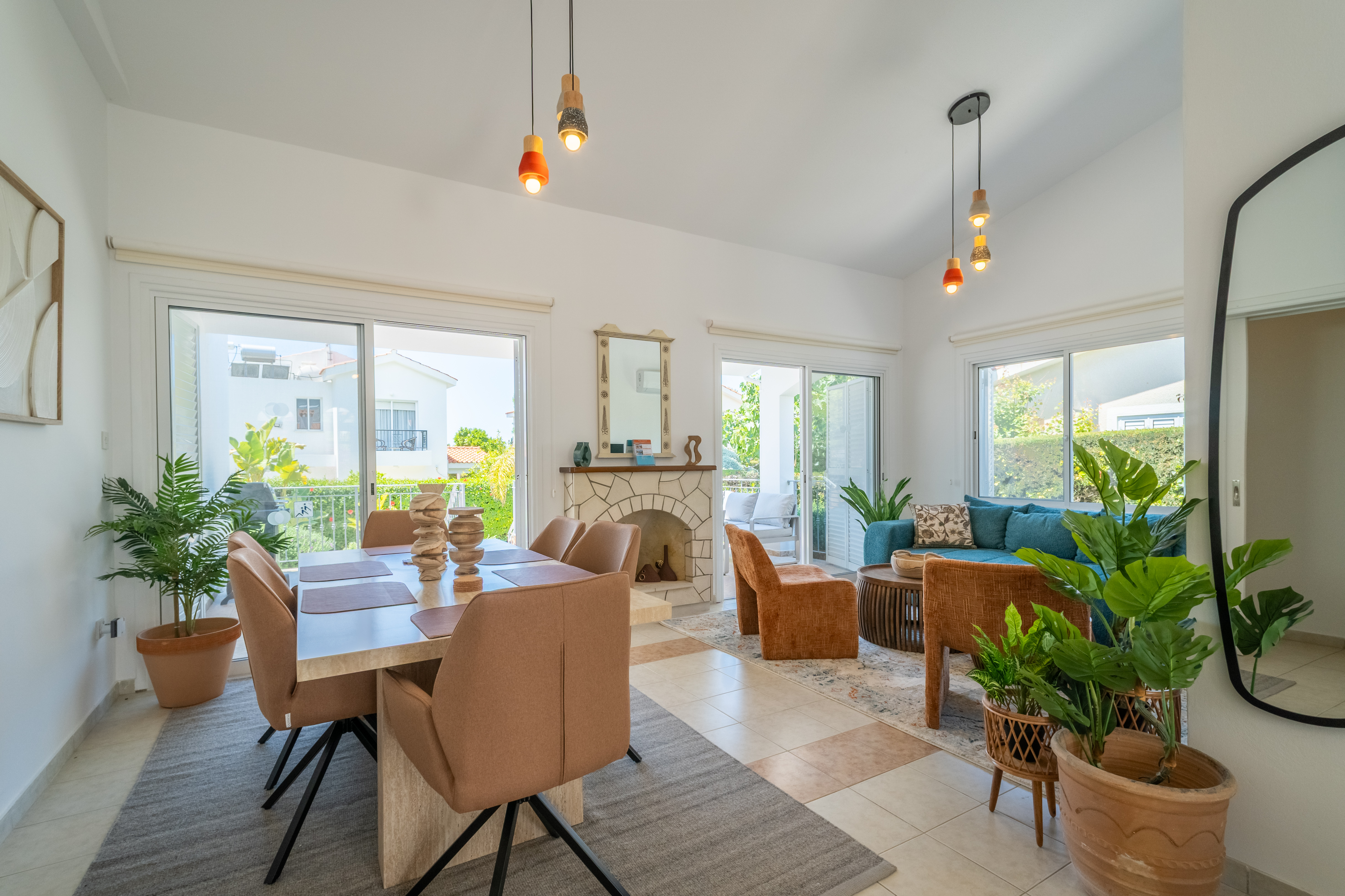 Sunny open-plan lounge & dining with patio access and chic fireplace