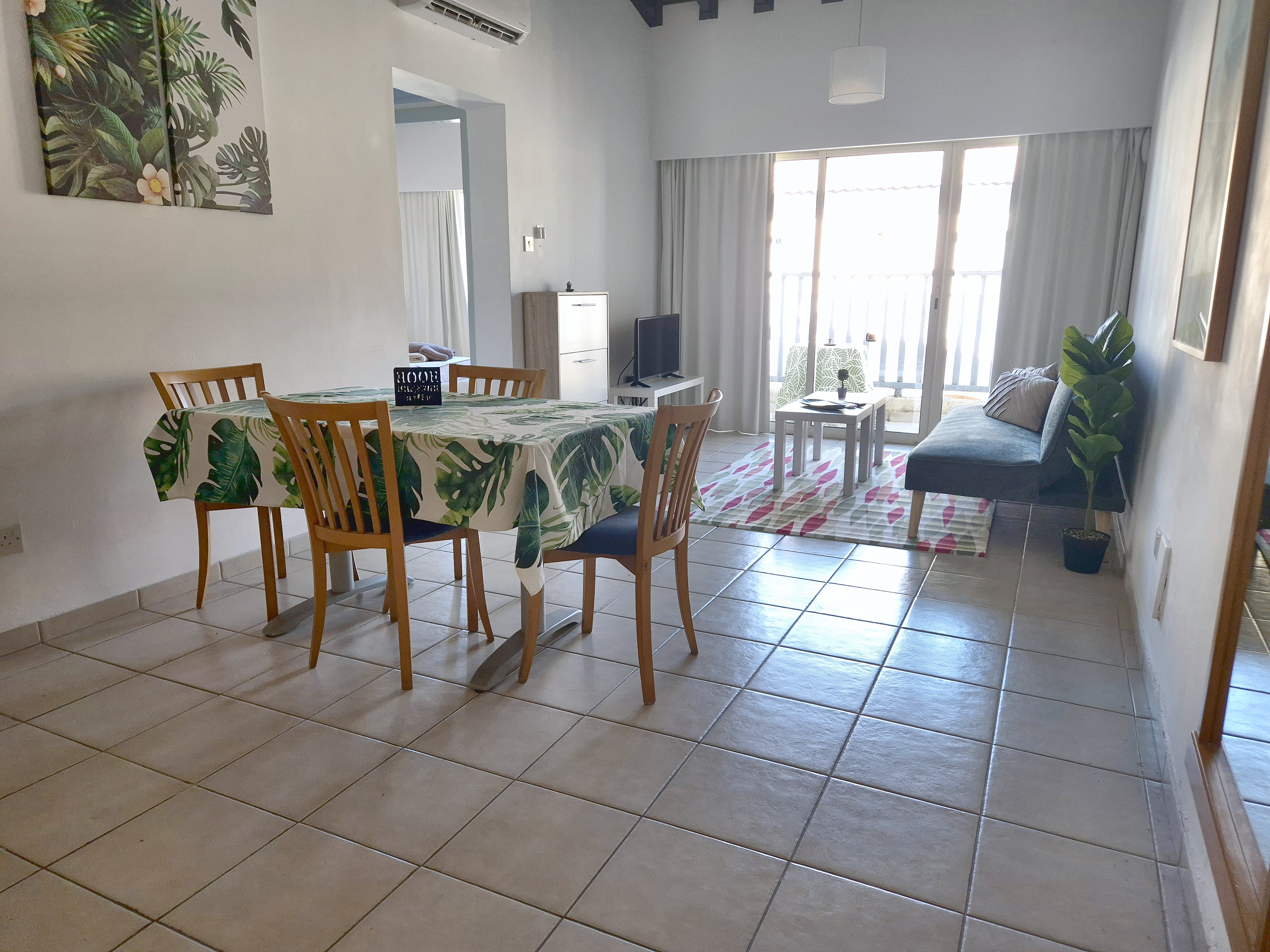 Living and dining room from the entrance, balcony ahead