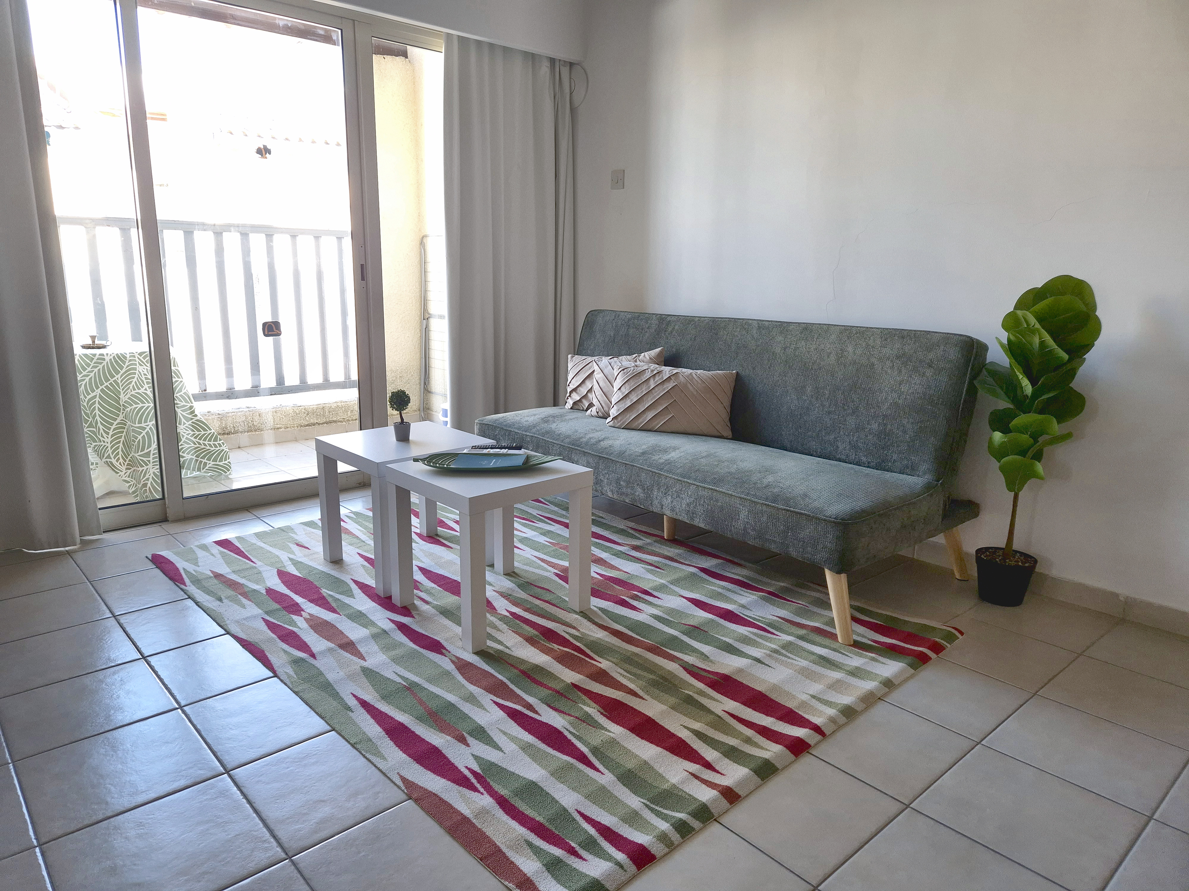 Sofa bed in the living room, balcony door