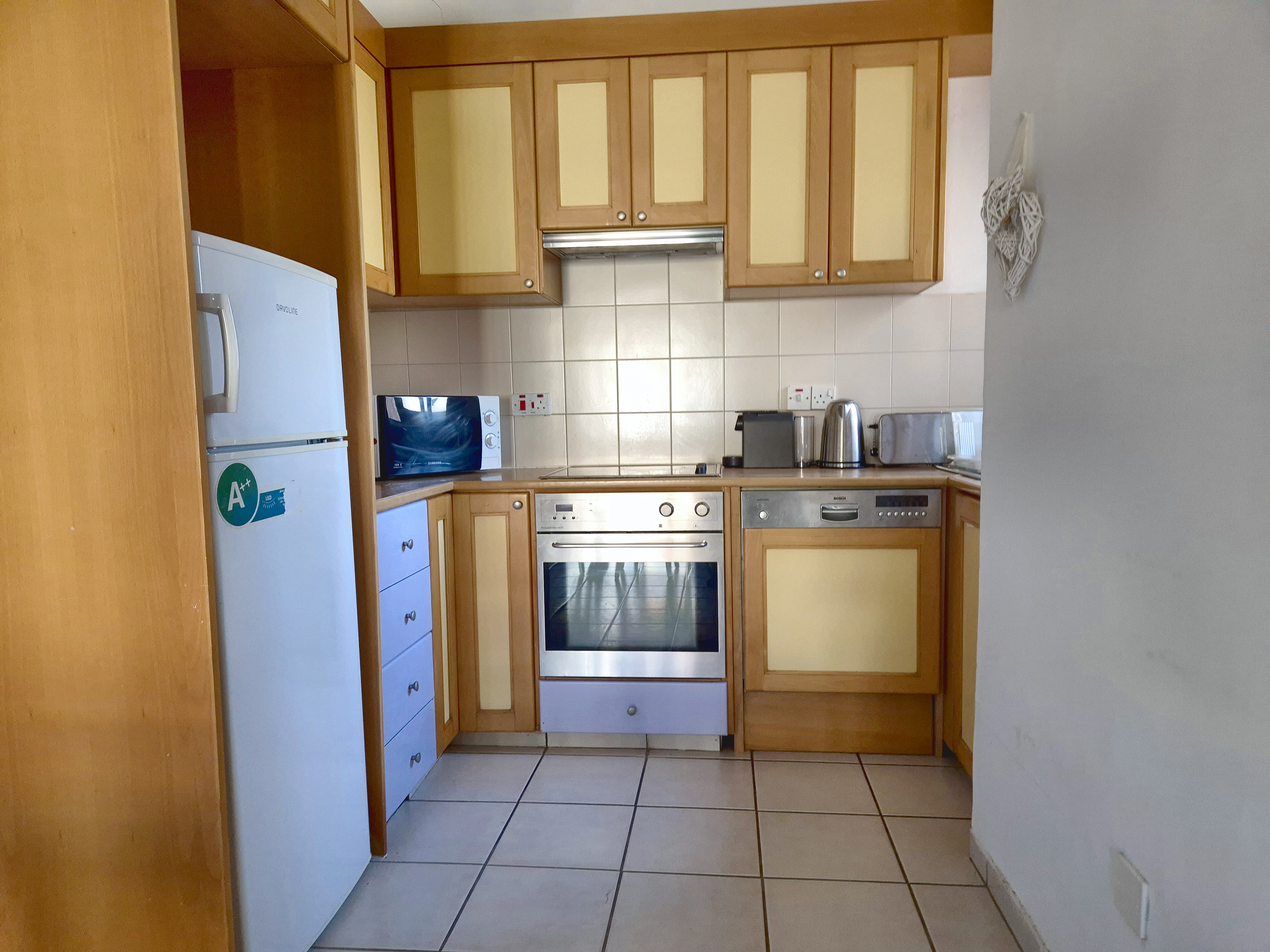 Kitchen with oven, dishwasher, fridge freezer and microwave