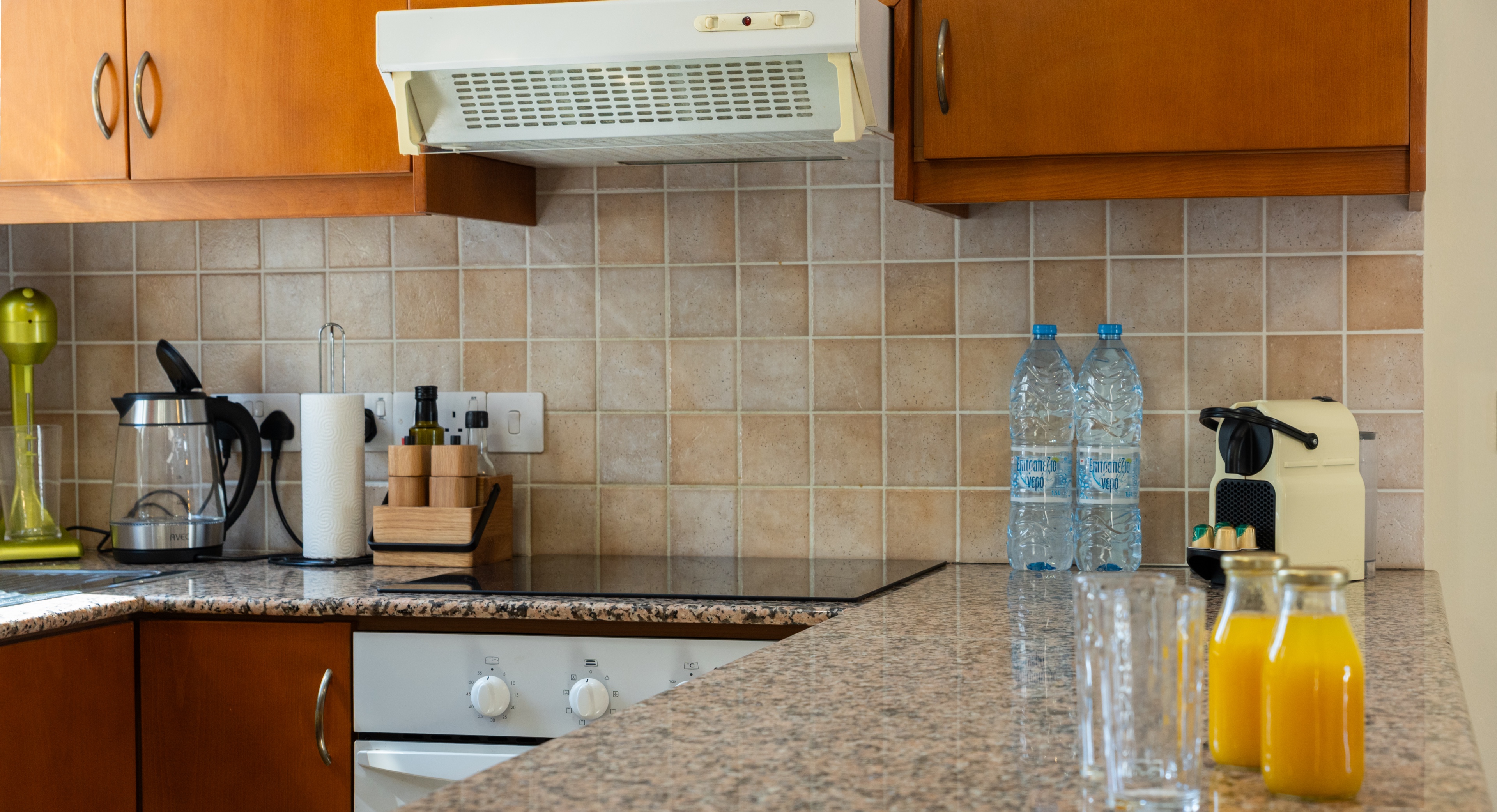 Cozy, well-equipped kitchen with granite tops and espresso maker