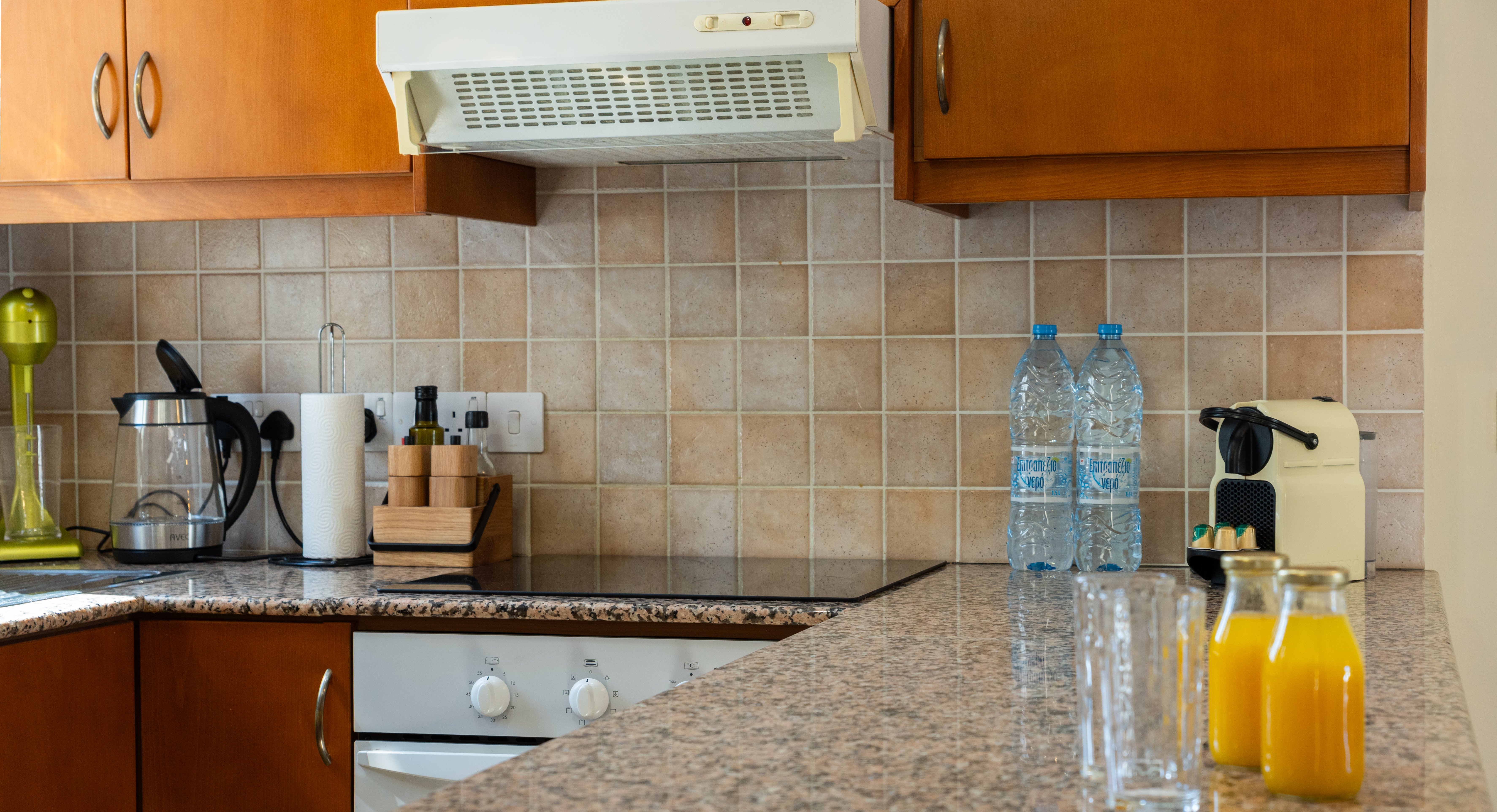 Cozy, well-equipped kitchen with granite tops and espresso maker